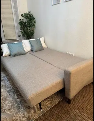 a bed with two pillows on it in a room at Stylish Glasgow Apartment in Whiteinch