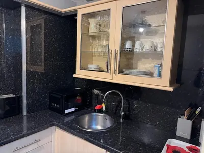a kitchen counter with a sink and a microwave at Stylish Glasgow Apartment in Whiteinch