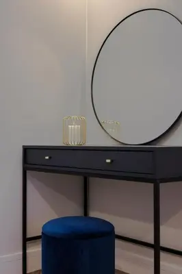 a black desk with a mirror and a blue stool at Old Church Apartment 2 in Oban
