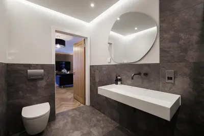 a bathroom with a sink and a toilet and a mirror at Old Church Apartment 2 in Oban