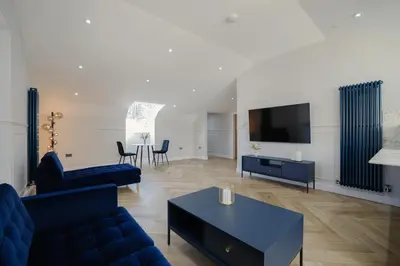 a living room with a couch and a tv at Old Church Apartment 4 in Oban