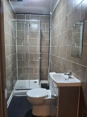 a bathroom with a toilet and a shower and a sink at Akwaaba services in Moffat