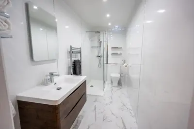 a white bathroom with a sink and a shower at Moffat Apartment with Hot Tub in Moffat