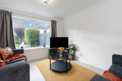 a living room with a couch and a table at Stylish 4Bed Home Free Parking 20 Min to Edinburgh in Livingston