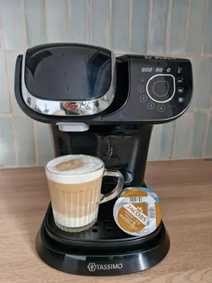 a coffee maker with a cup of coffee at Justina's House in East Kilbride