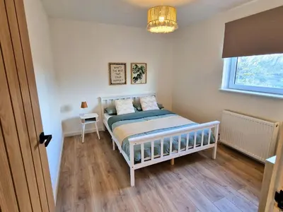 a small bedroom with a bed and a window at 7 min from Edinburgh Airport 2 Bedroom Apartment in Edinburgh