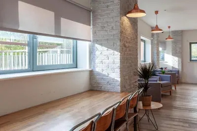 a room with a row of chairs and windows at Collegelands in Glasgow in Glasgow