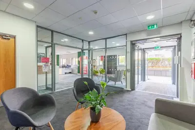 an office with two chairs and a wooden table and a table sidx sidx at Collegelands in Glasgow in Glasgow