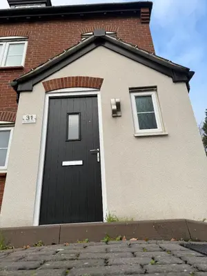 a house with a black door on the side of it at Pearl House in Moffat