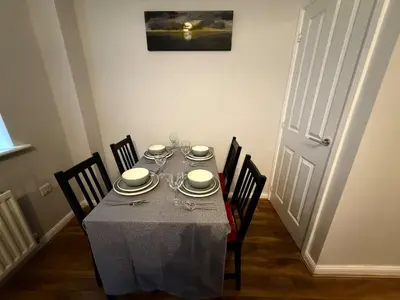 a dining room table with a gray tablecloth on it at Pearl House in Moffat