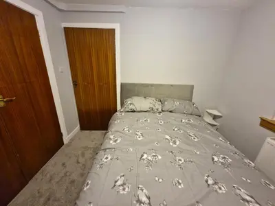 a bed in a bedroom with a bedspread with sheep on it at Spacious 2 Bed in Falkirk in Falkirk