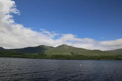 a view of a lake with mountains in the background at Ardeonaig Lodge with Hot Tub & Water Fronted Games room in Ardeonaig