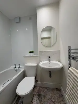 a bathroom with a toilet and a sink and a mirror at Castle flat in Edinburgh in Edinburgh