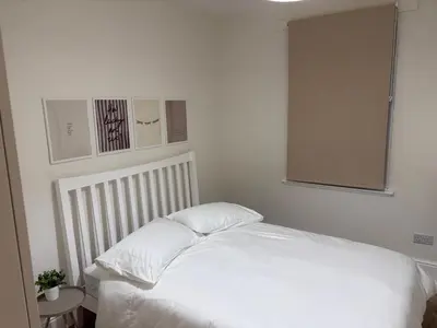 a white bed with two pillows in a bedroom at Castle flat in Edinburgh in Edinburgh