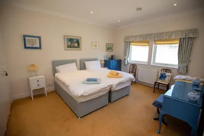 a bedroom with a large bed and a window at Sevenacres Kelso in Moffat