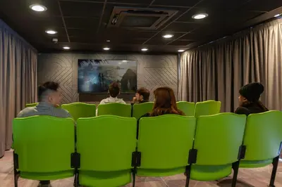 a group of people sitting in chairs watching a movie at For Students Only Stylish Studios in Glasgow in Glasgow