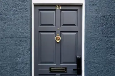 a blue door with a gold knocker on it at Near Transport - Hot tub - Fireplace - Sleeps 2 in Edinburgh