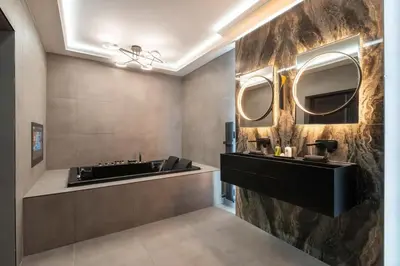 a bathroom with a sink and two mirrors on the wall at Near Transport - Hot tub - Fireplace - Sleeps 2 in Edinburgh