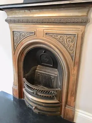 an old woodburning fireplace in a room at Heart Of Edinburgh City Flat in Edinburgh