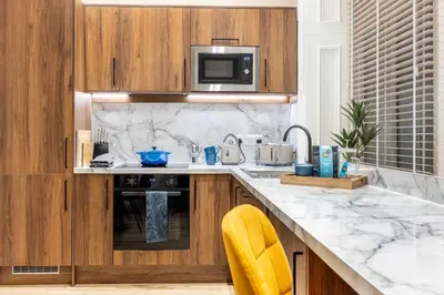 a kitchen with a sink and a microwave at The Steamie on Bath St in Glasgow