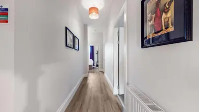 a hallway with white walls and a picture on the wall at The Steamie on Bath St in Glasgow