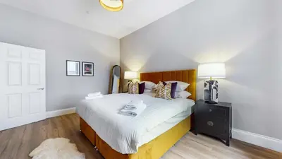 a bedroom with a bed and a tv on a table at The Steamie on Bath St in Glasgow