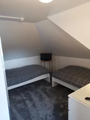 a room with two beds in a attic at Glenfern Guest House and a separate Cottage with its own private hot tub in Balloch