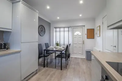 a kitchen and dining room with a table and chairs at Catriona House - 3 Bedroom house in Motherwell in Holytown