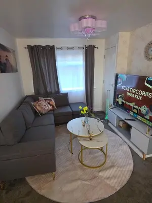 a living room with a couch and a table and a tv at The Jet Nest in Moffat