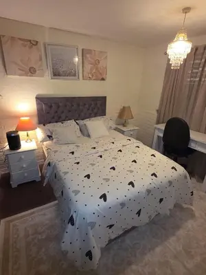 a bedroom with a bed with a black and white comforter at The Jet Nest in Moffat