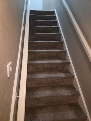 a stairway in a house with brown carpet at The Jet Nest in Moffat