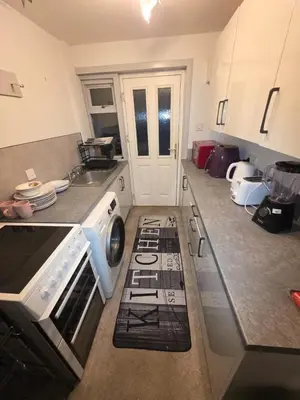 a kitchen with a stove top oven next to a sink at The Jet Nest in Moffat