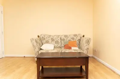 a living room with a couch and a coffee table at 2 bed flat near Livingston North Station in Livingston