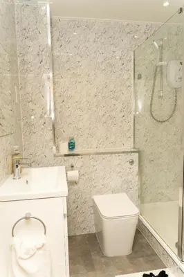 a bathroom with a sink and a toilet and a shower at 2 bed flat near Livingston North Station in Livingston