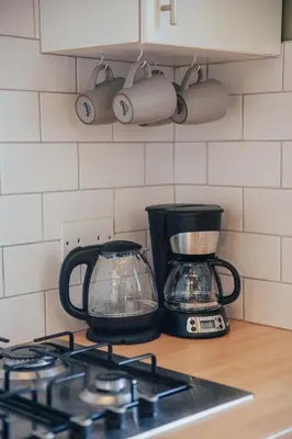 a kitchen counter with a coffee maker and a blender at Snug 1 Bed Apartment in Edinburgh's Juniper Green in Edinburgh