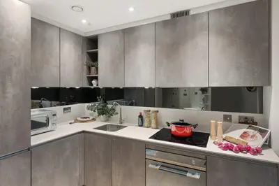 a kitchen with stainless steel cabinets and a microwave at Bright 3BR London Flat w Full Kitchen in Moffat