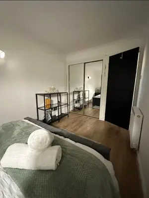 a bedroom with a bed with white towels on it at Hydro Secc House Glasgow 10 minute walk in Glasgow