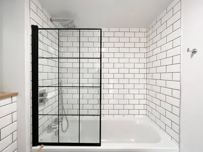 a bathroom with a tub with a glass shower at Stunning River View City Centre Apartment in Glasgow