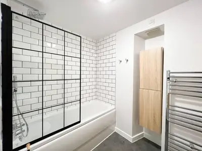 a bathroom with a bath tub and a shower stall at Stunning River View City Centre Apartment in Glasgow
