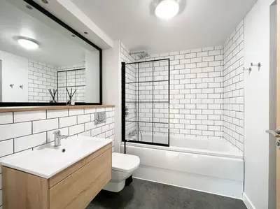 a bathroom with a sink and a tub and a toilet at Stunning River View City Centre Apartment in Glasgow