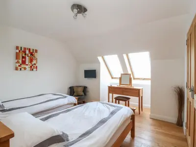 a bedroom with two beds and a desk at Lurach House in Appin