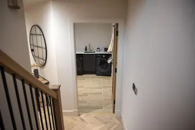 a hallway with a washer and dryer in a house at Highland House in Lochearnhead