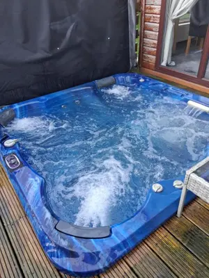 a jacuzziificialificialificialificialificialificialificialificialificialificialificial at Redwood lodge with luxury hot tub at Three lochs holiday park in Balminnoch