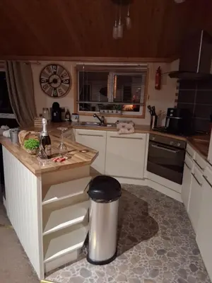a kitchen with a counter and a trash can at Redwood lodge with luxury hot tub at Three lochs holiday park in Balminnoch