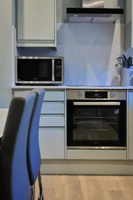a kitchen with a microwave and a oven at Gordon's Getaway Lux in Oban