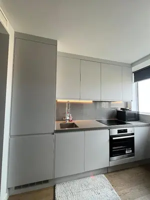 a kitchen with white cabinets and a sink at Modern City Apartment, Fast Wi-Fi, Great View in Moffat