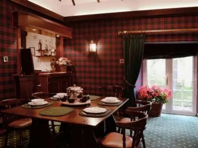 a dining room with a table and some chairs at Holiday Home Gehöft 4 by Interhome in Tweedsmuir