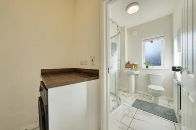 a bathroom with a shower and a toilet and a sink at Stylish and Morden 3Bed House Glasgow City Centre in Glasgow