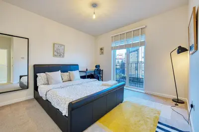 a bedroom with a bed and a large window at Stylish and Morden 3Bed House Glasgow City Centre in Glasgow