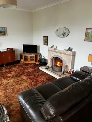 a living room with a couch and a fireplace at Lynndale in Carradale